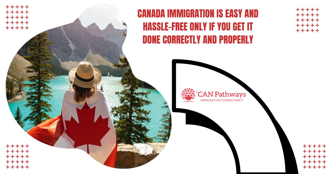 A women standing in front of Lake wrapped Canada Flag around her body